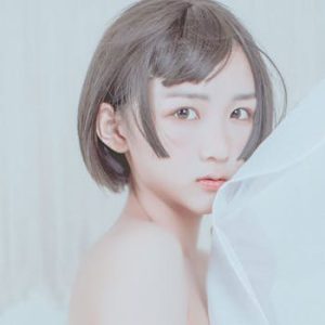 pexels-photo-17784385-17784385 Gentle portrait of a young woman with a short haircut, partially wrapped in fabric.